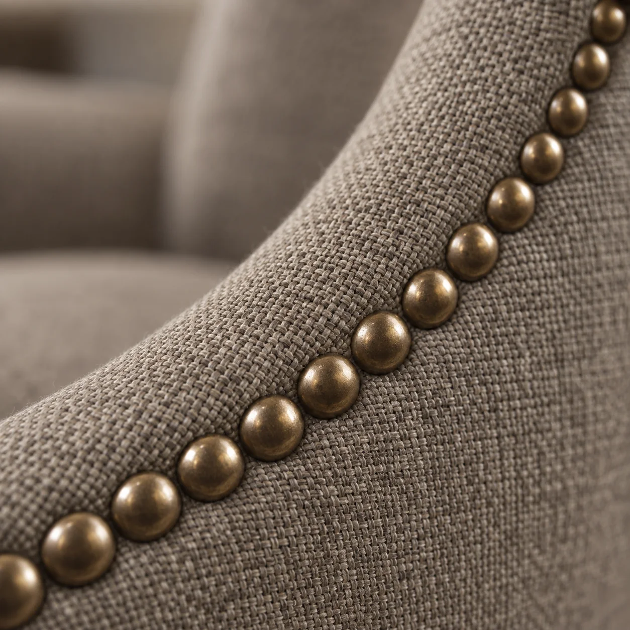 Curved run of antique-brass nailheads on a dining chair back