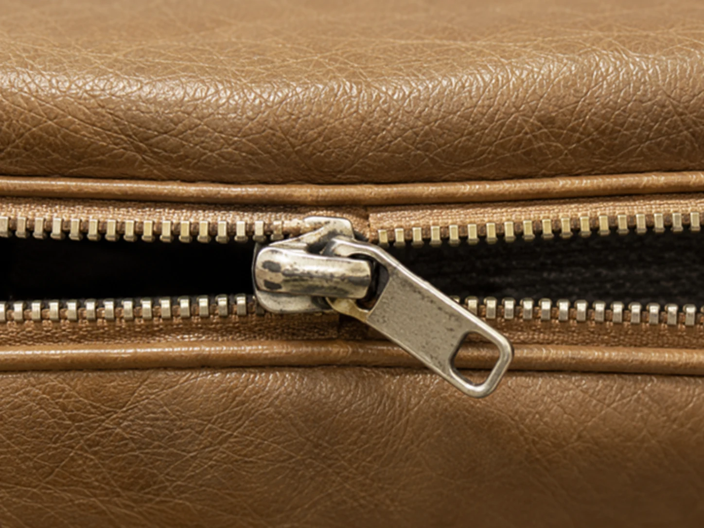 Close-up of a metal zipper on a leather cushion cover boxing