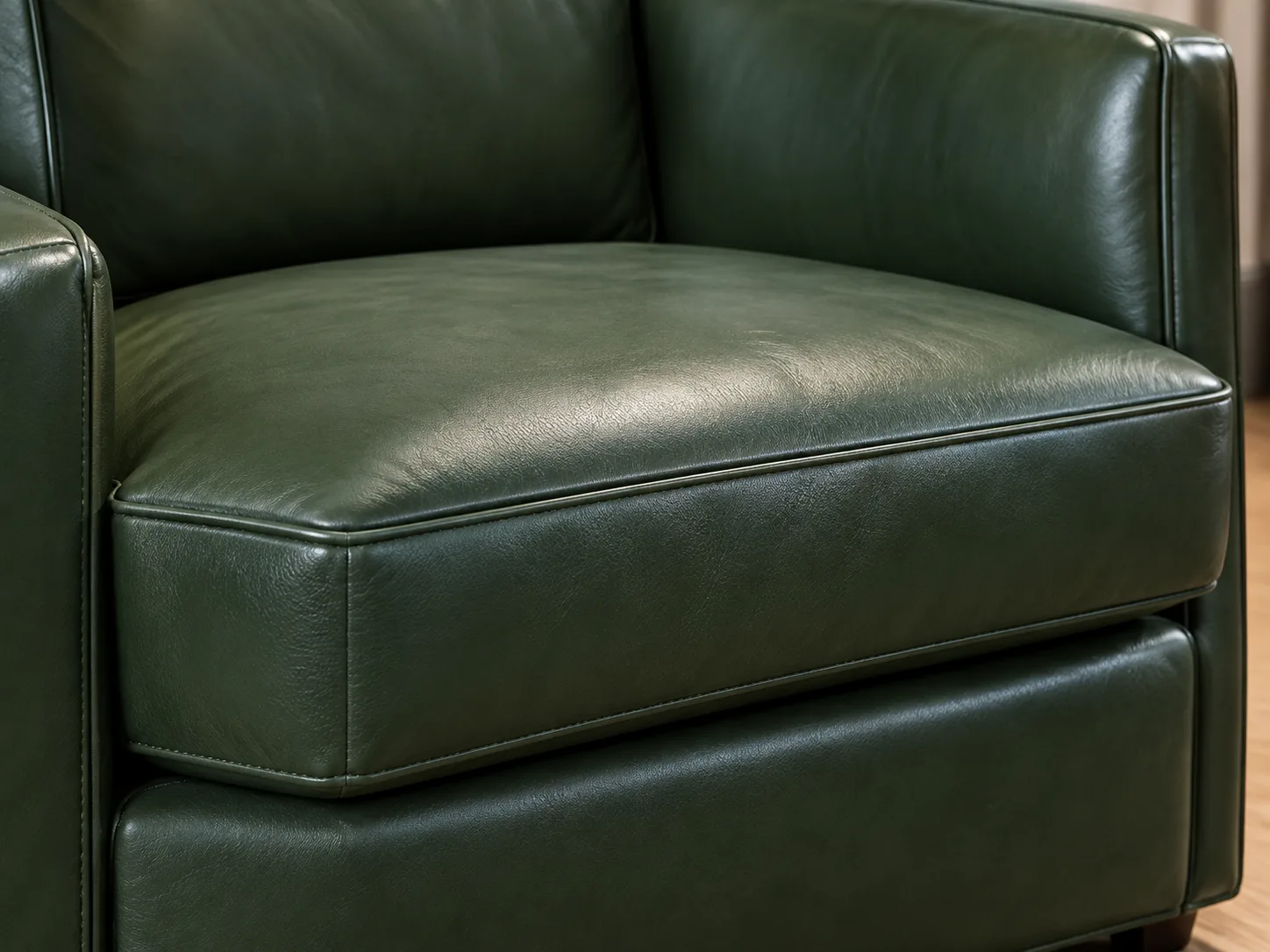 Green leather club chair cushion checked for collapsed support