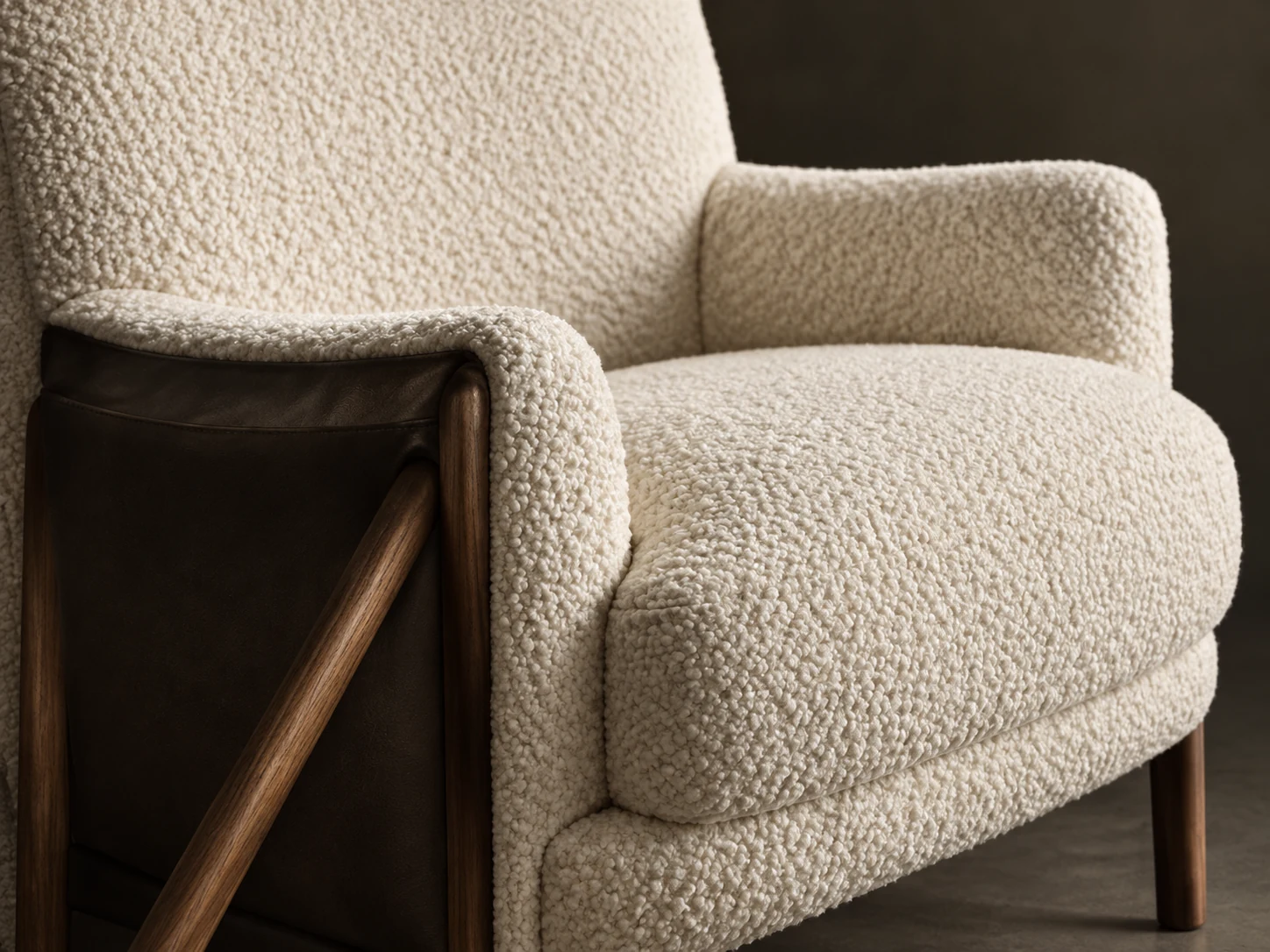Boucle armchair on an exposed walnut frame