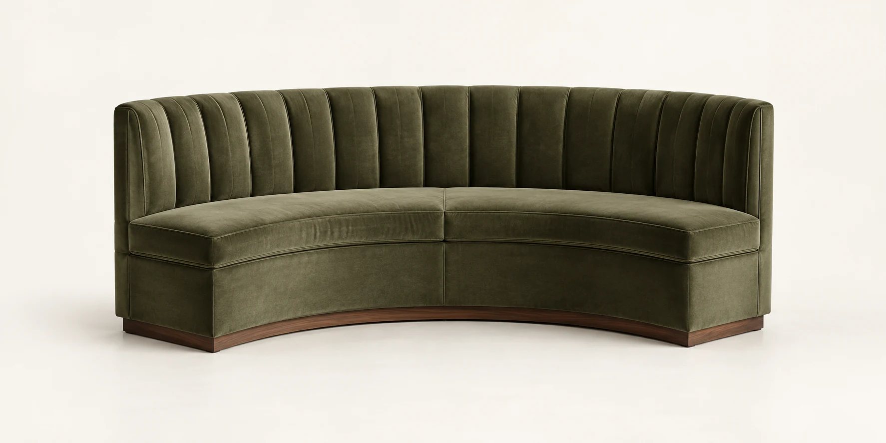 Freestanding curved banquette in green velvet on a plain background