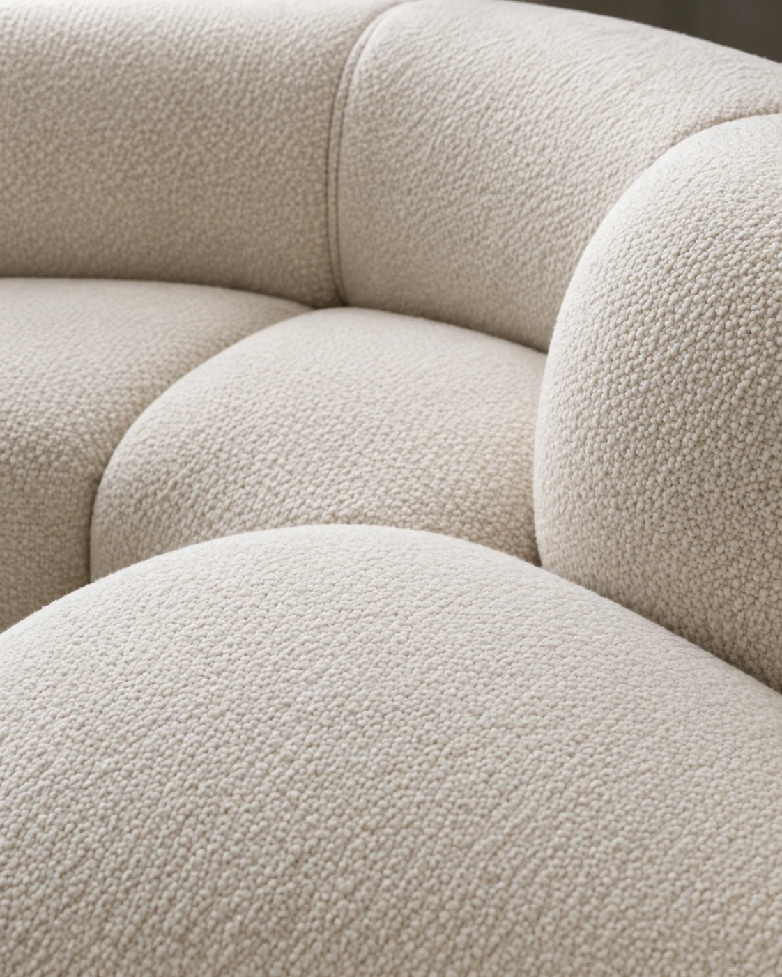 Curved boucle sofa arm with the frame fully covered