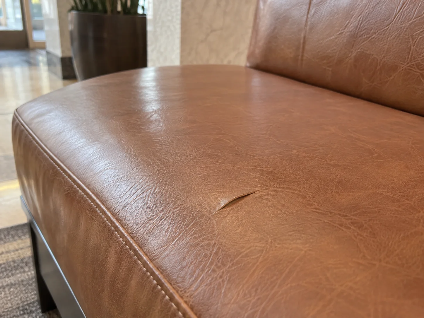 A cut in a leather bench cushion