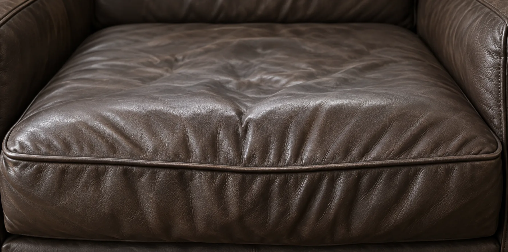 Creased dark brown leather seat cushion
