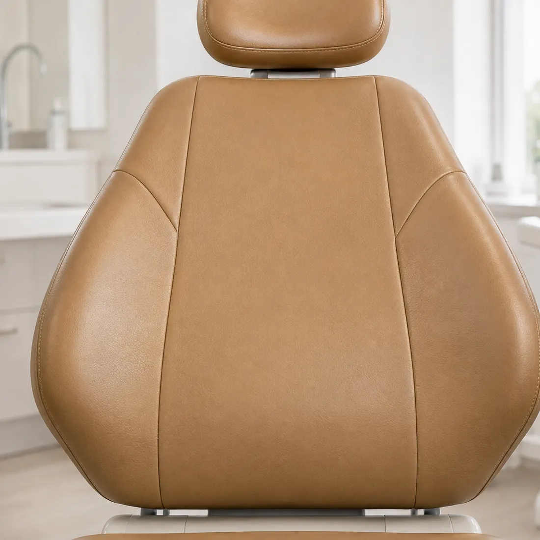 Tan vinyl dental chair backrest with stitched side bolsters