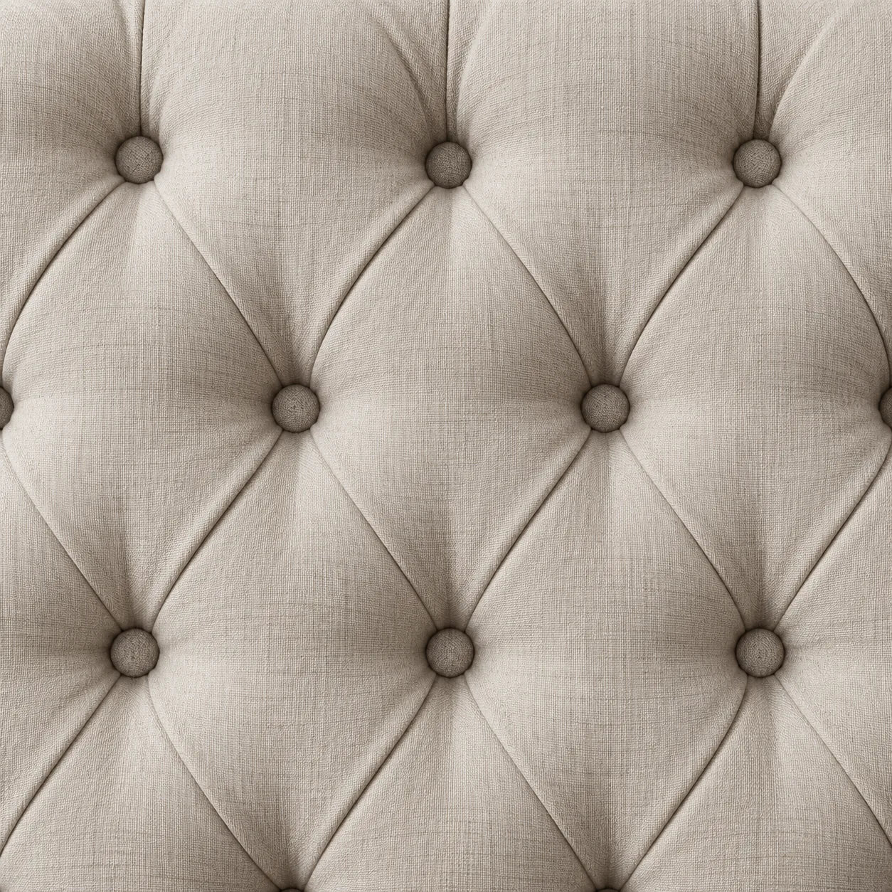 Diamond button tufting detail in cream linen with softer folds