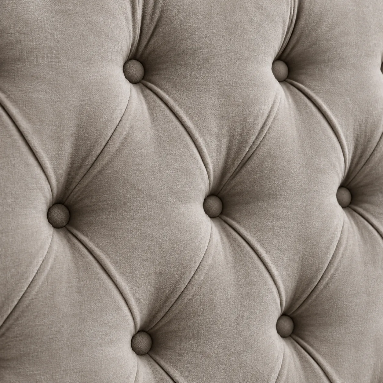 Diamond button tufting detail in taupe velvet with pressed folds