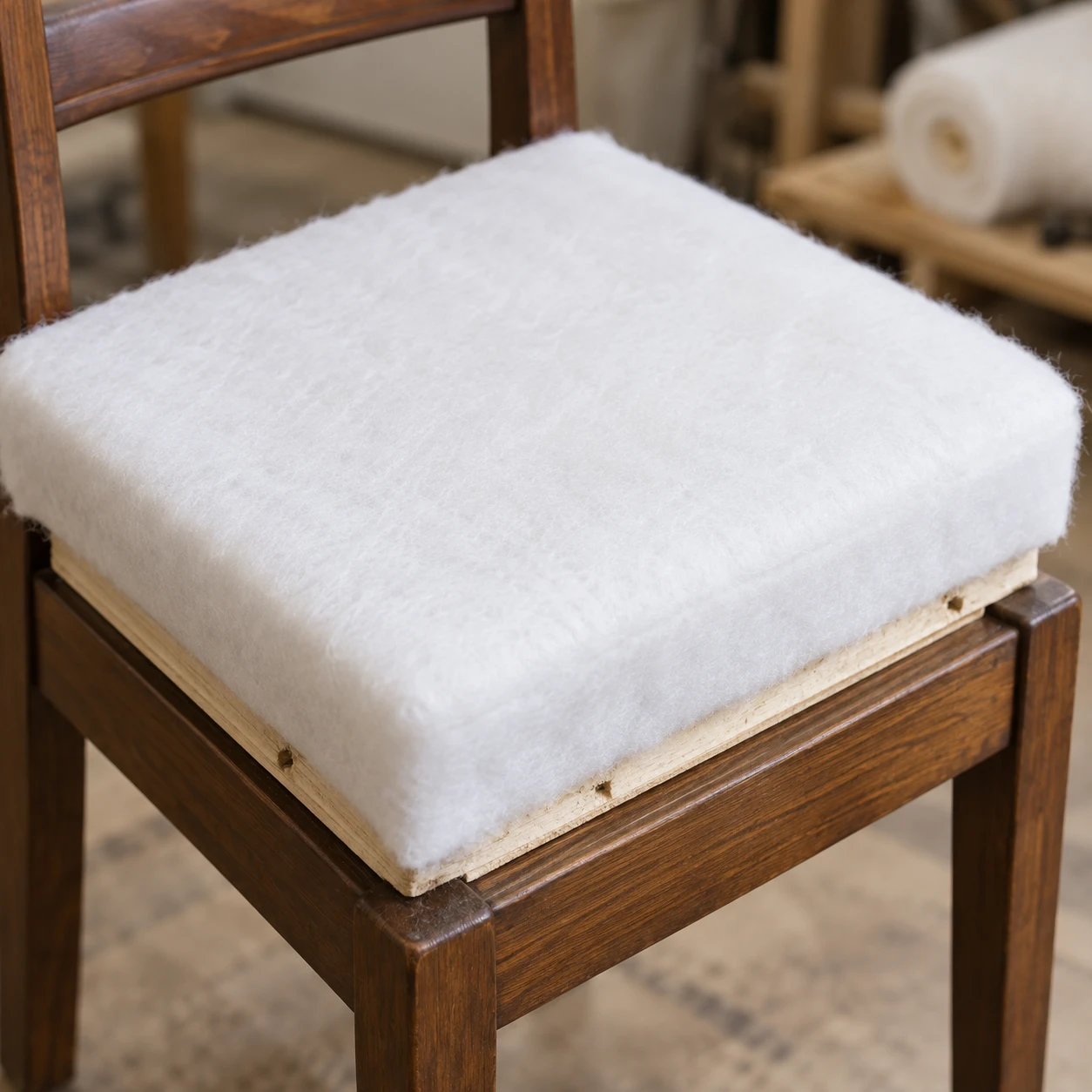 Padding fitted to a dining chair seat board