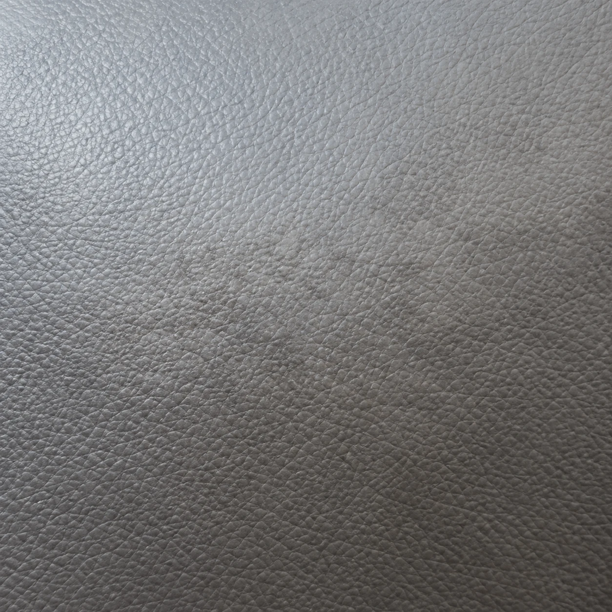 Discolored worn patch on gray medical vinyl