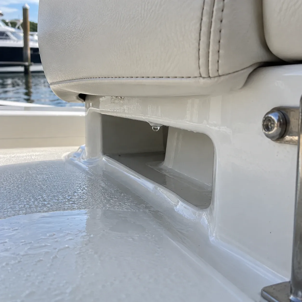 A drain channel running under a boat seat base