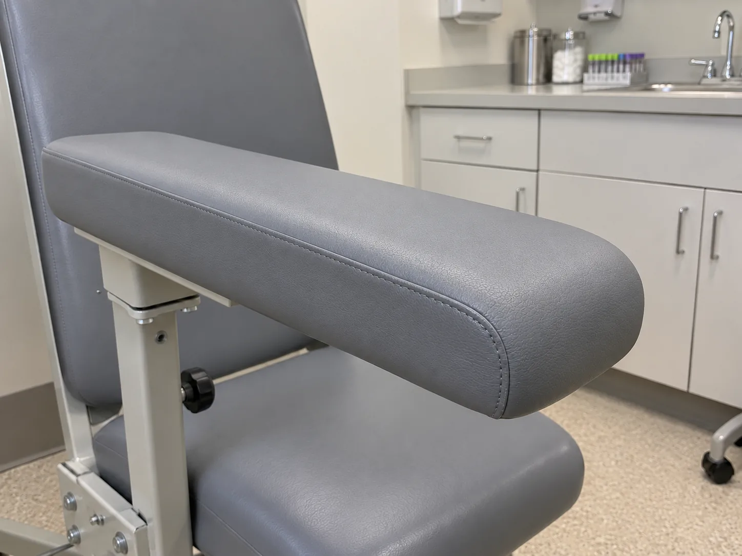 The same draw-chair arm recovered in grey vinyl
