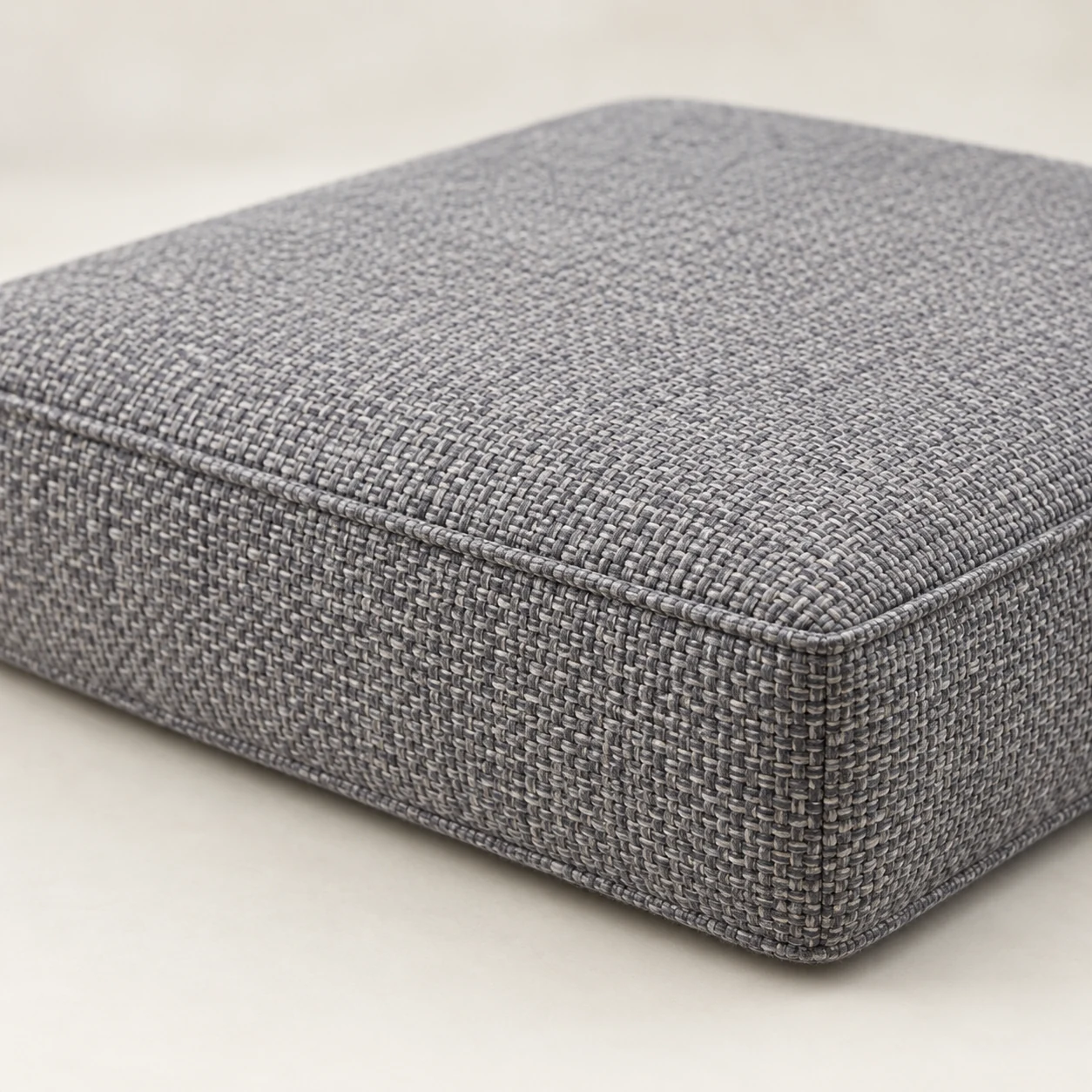 Grey tweed seat cushion made up in a designer supplied fabric