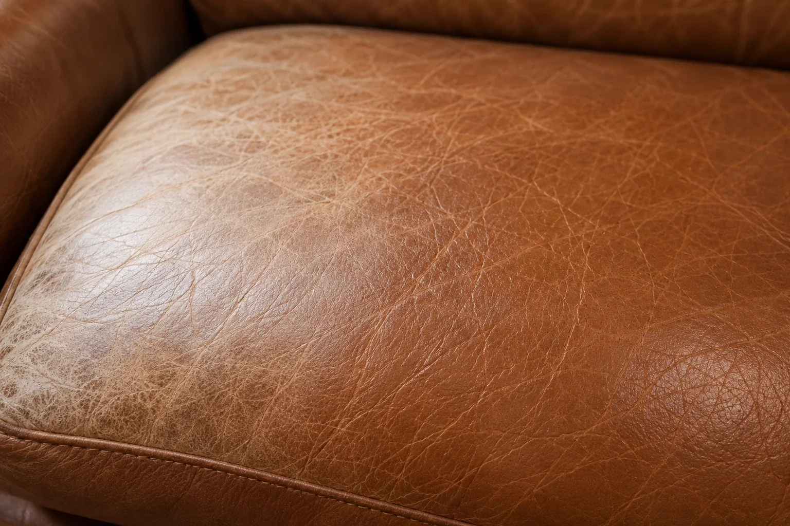 Leather faded evenly across a cushion
