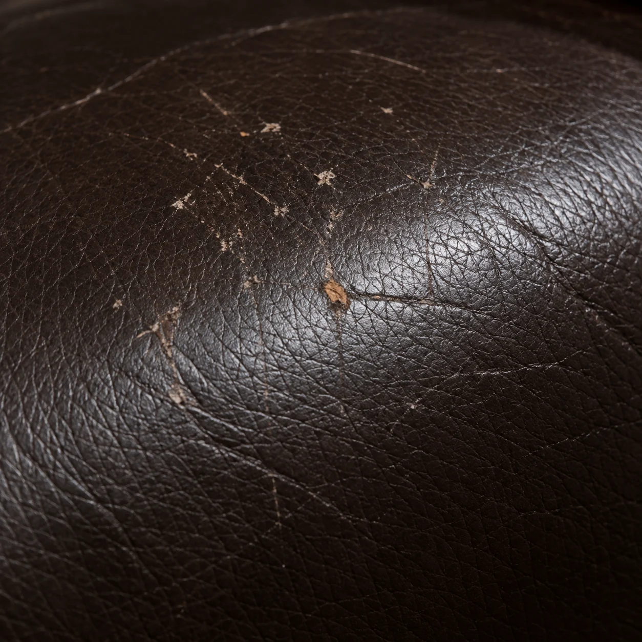 Fine crazing cracks in brown leather