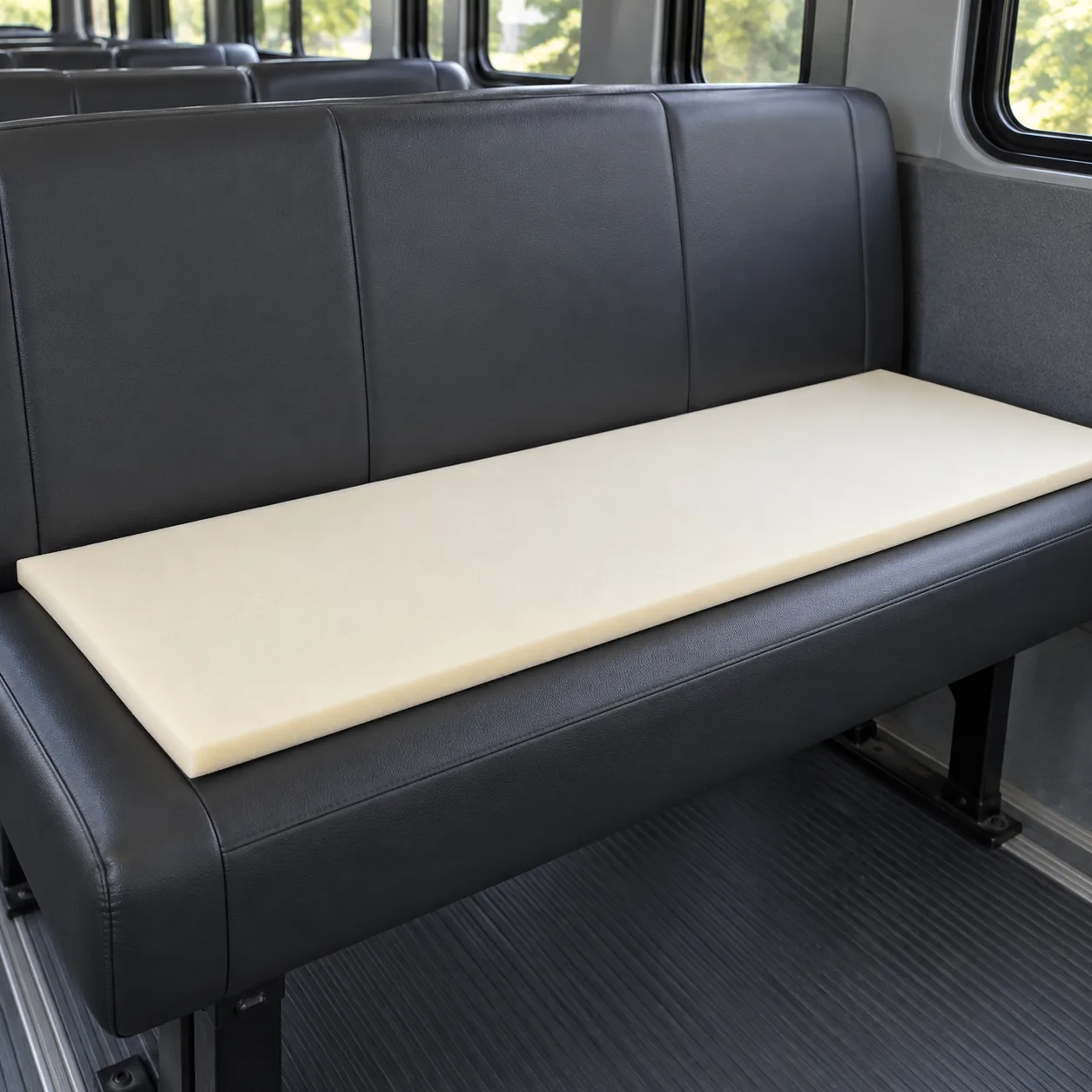A thin topper foam sheet laid on a bench seat