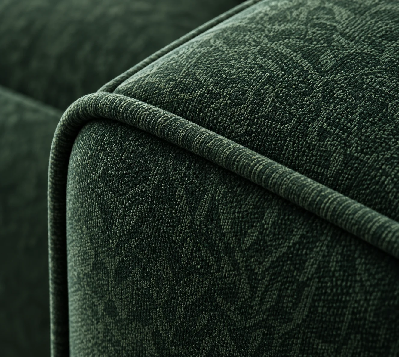 Green jacquard chair arm with a matching self-welt cord along the top edge