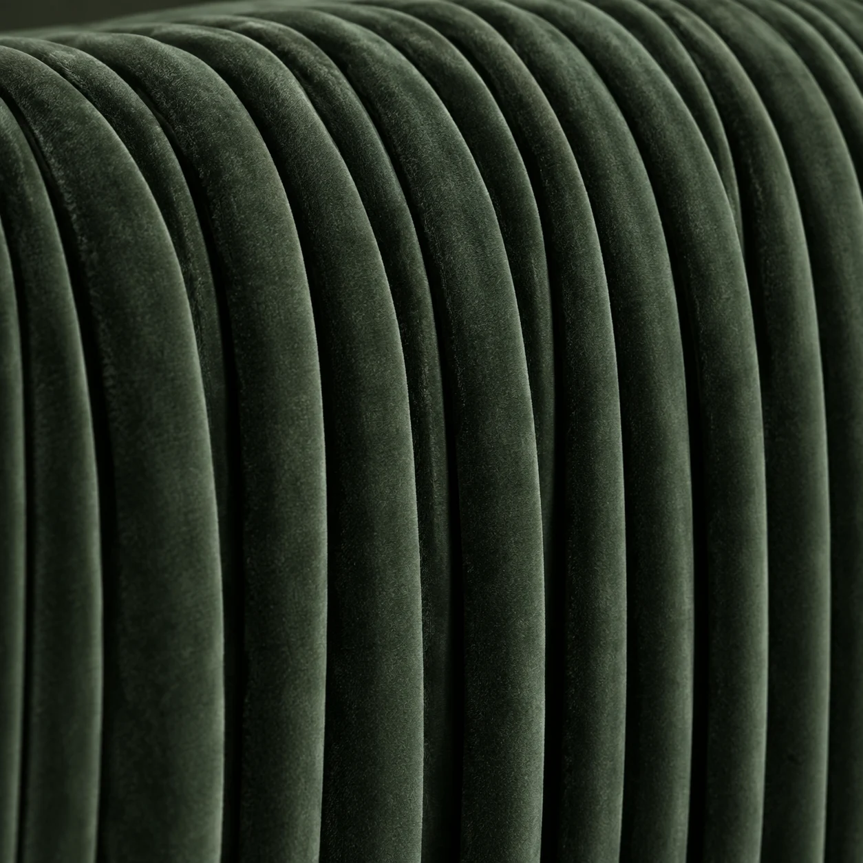 Green velvet chair back with narrow vertical channel tufting