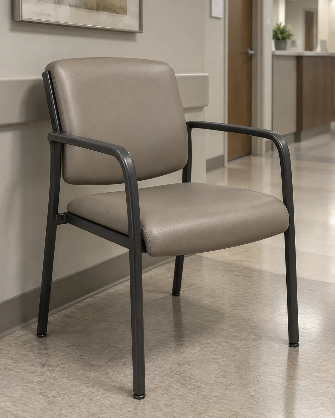A slim metal-frame guest chair in taupe vinyl