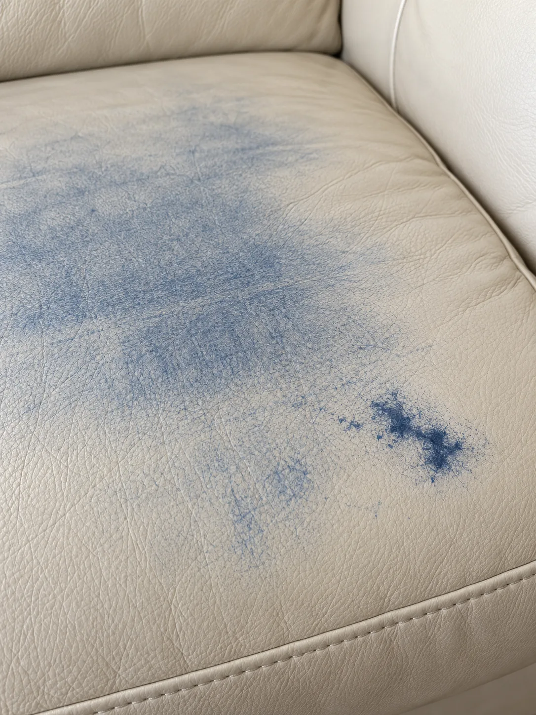 Blue denim dye rubbed onto a cream leather seat