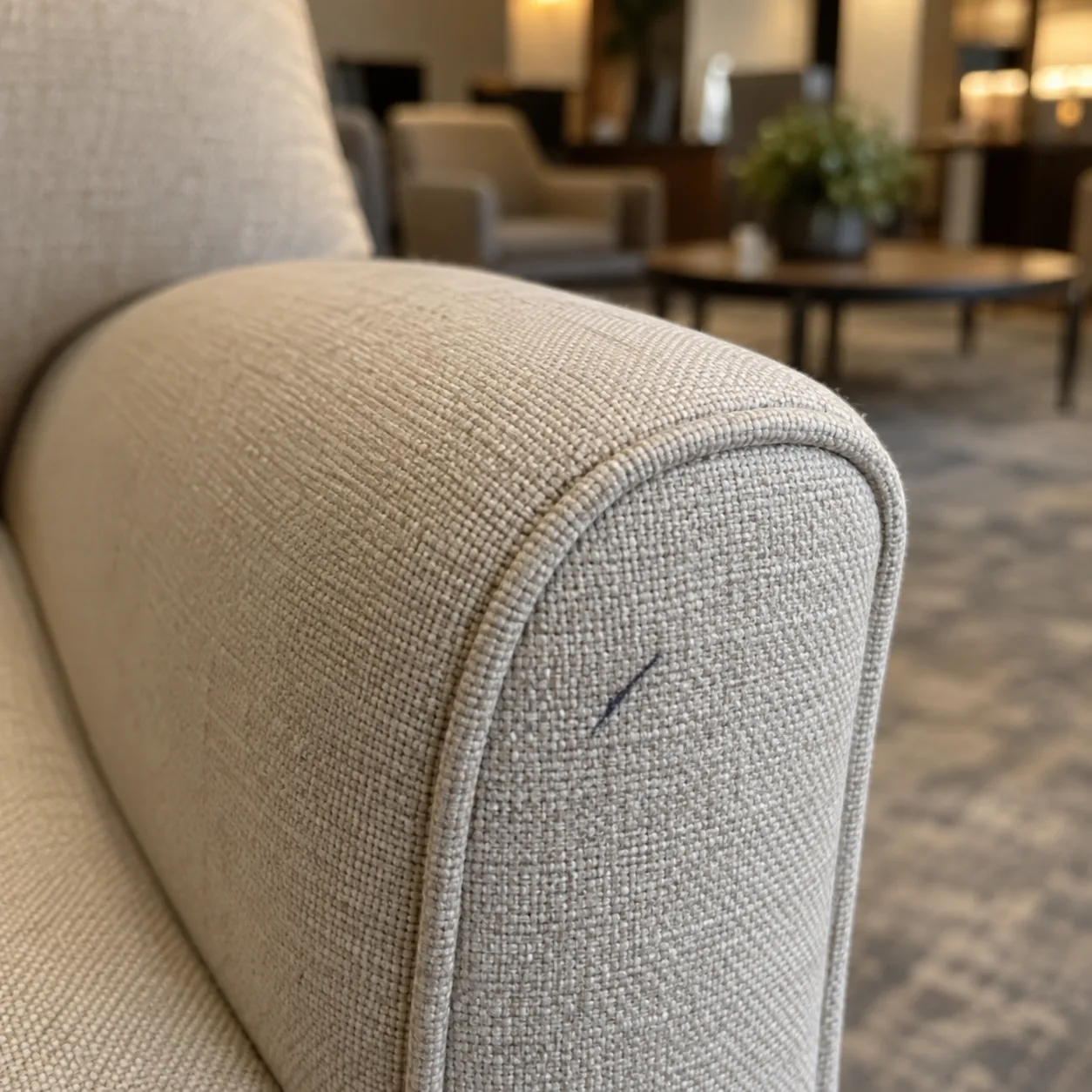 A pen mark on the arm of a light amenity chair