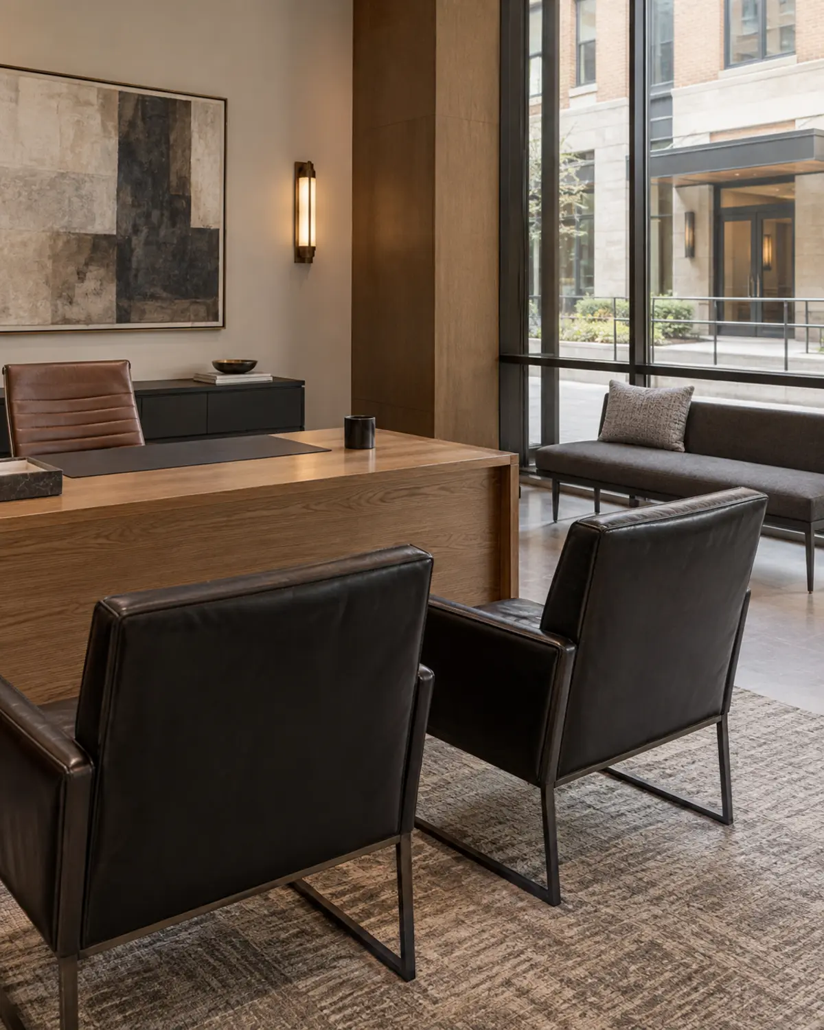 Two black leather guest chairs in a leasing office