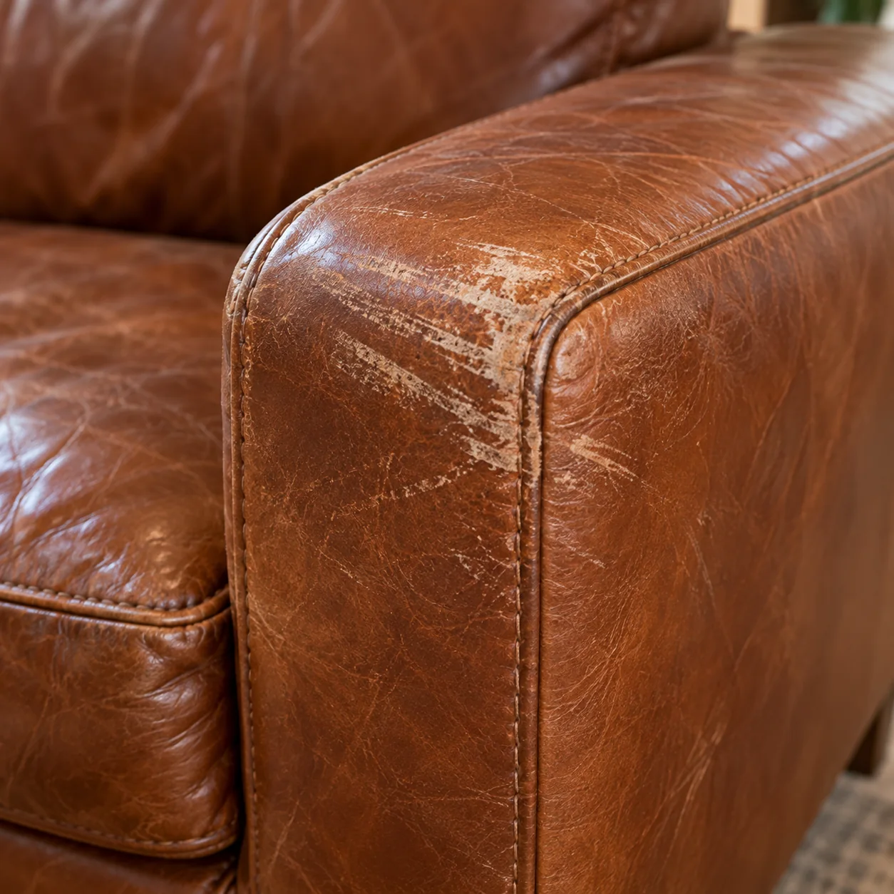 A leather sofa armrest scuffed during a move
