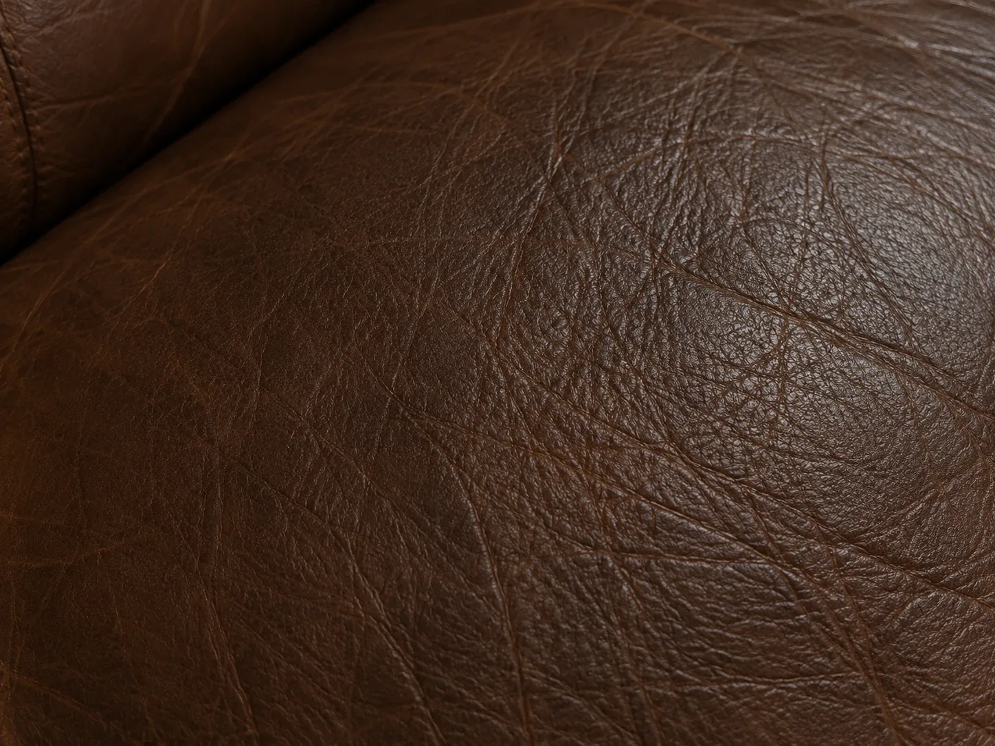 Dark patch of body oil soaked into brown leather