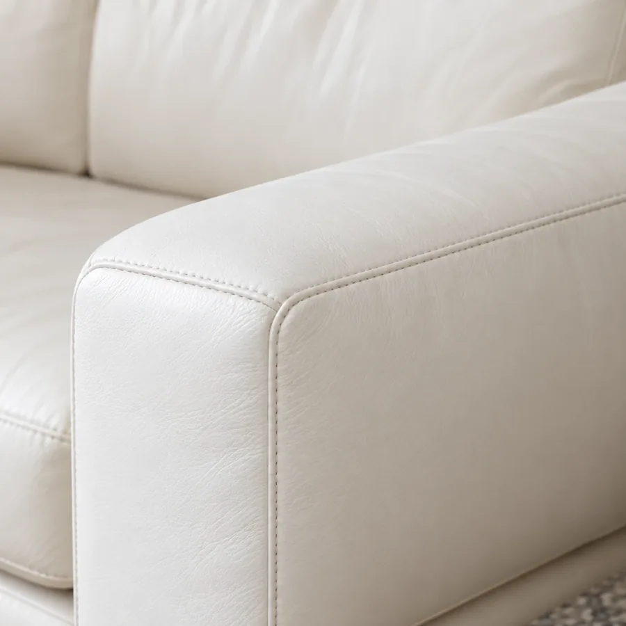 Conditioner worked into the arm of a brown leather sofa