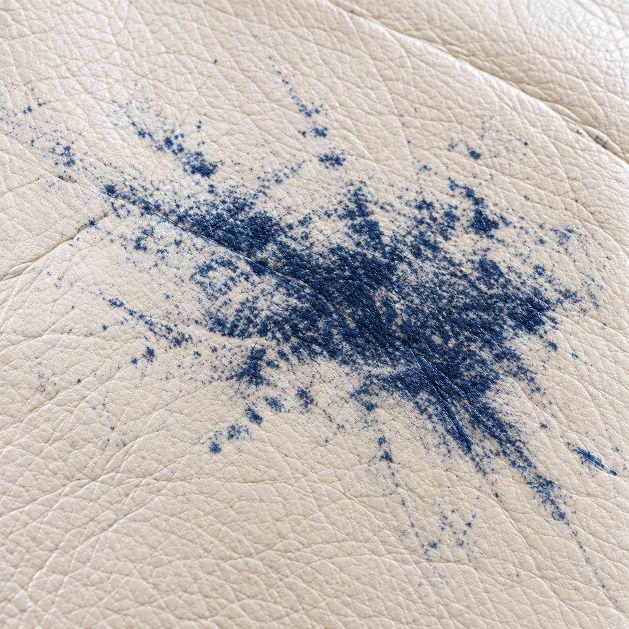 Blue dye transferred from clothing onto a pale leather seat