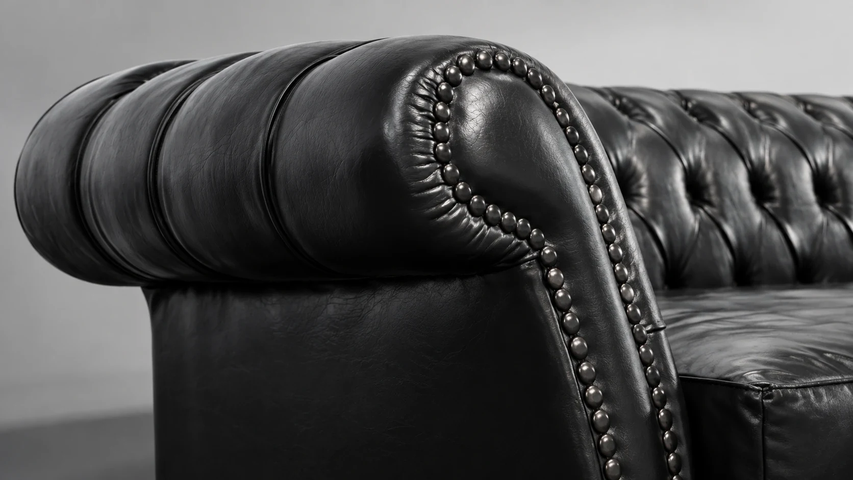 Black tufted leather sofa arm