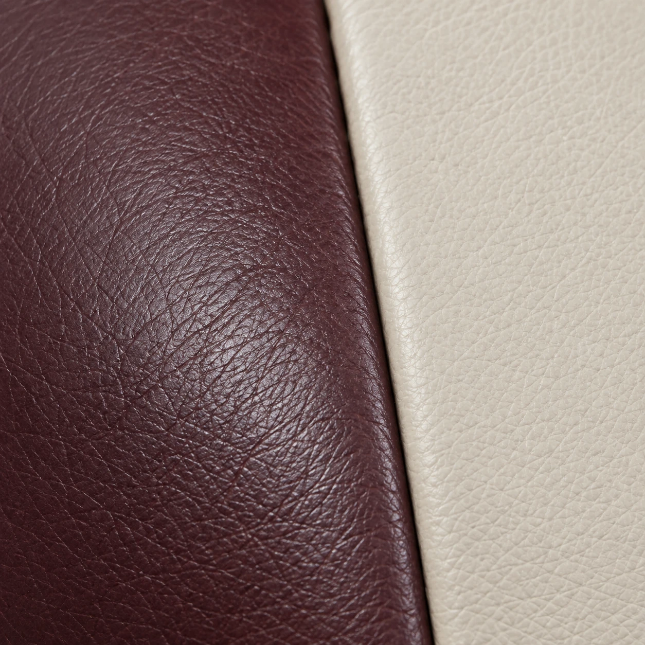 A single burgundy leather panel on a sofa seen against its neighbouring sections