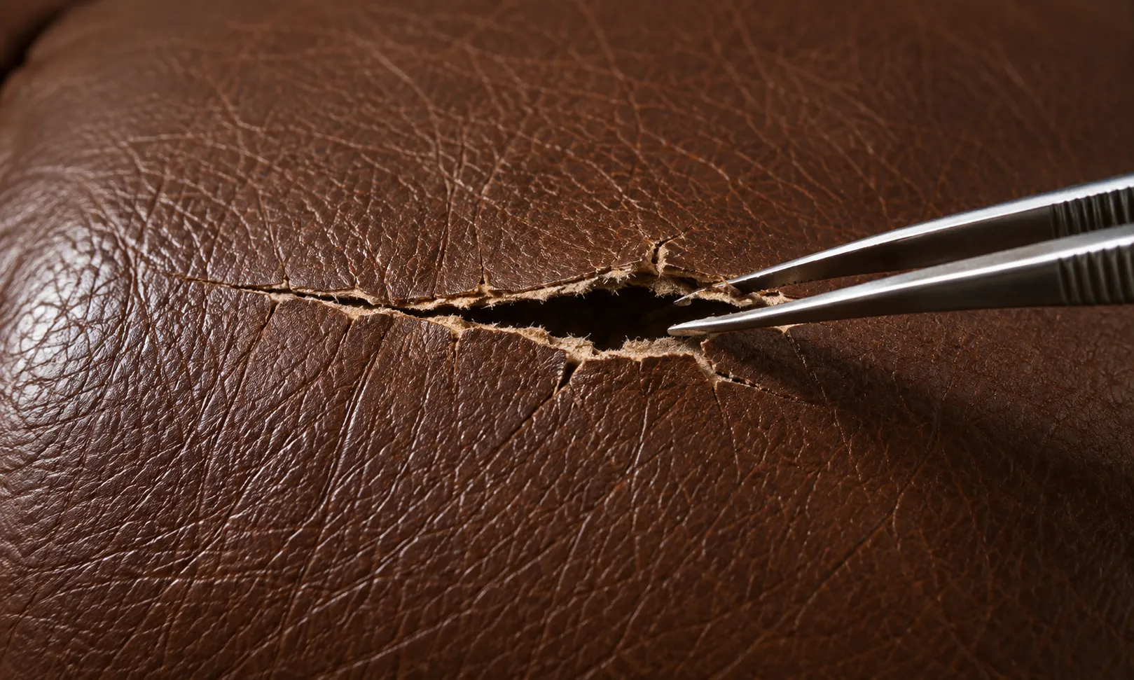 Tweezers aligning the edges of a tear