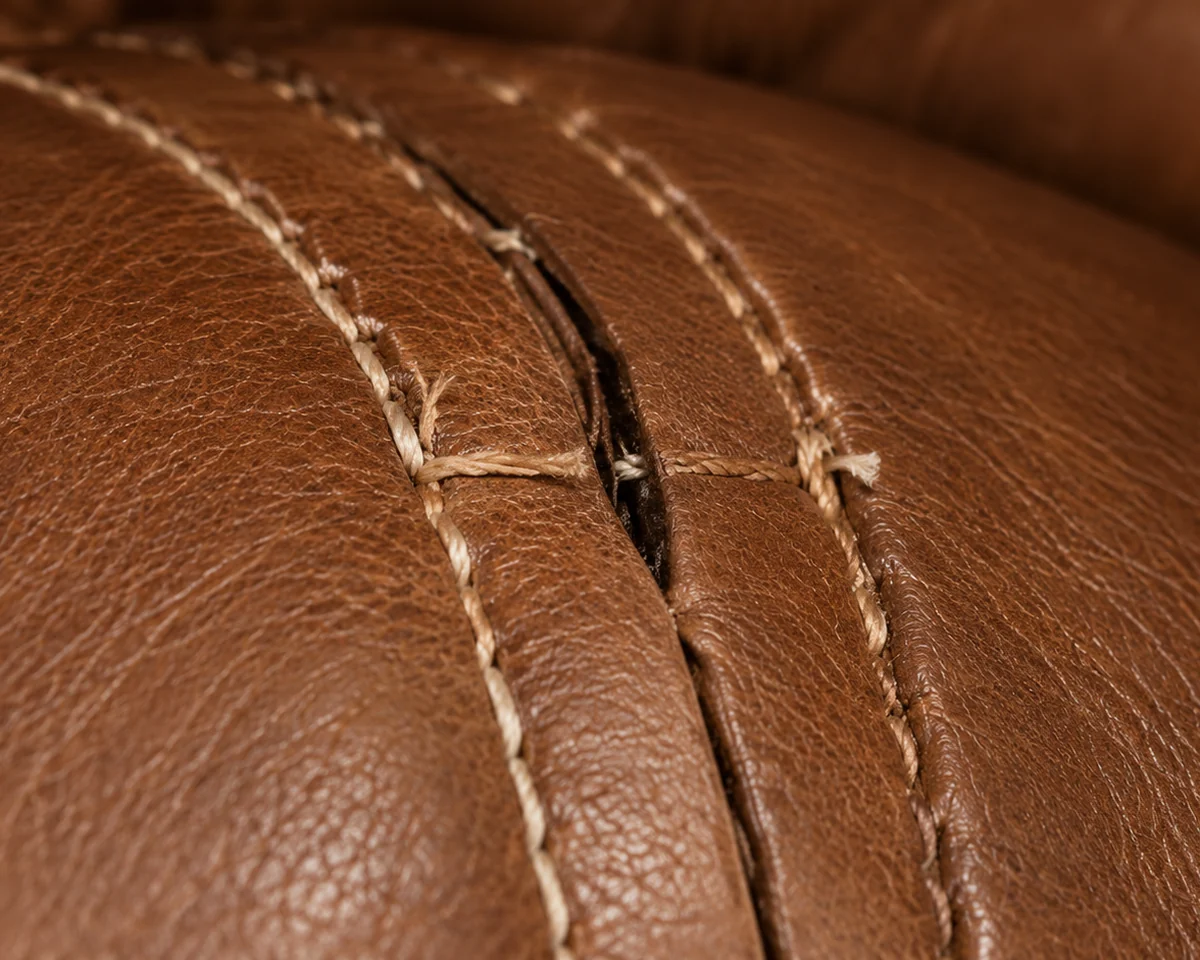 Double-stitched seam opening on a brown cushion