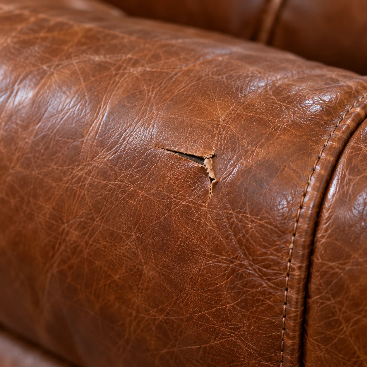 A cut in a leather sofa from moving