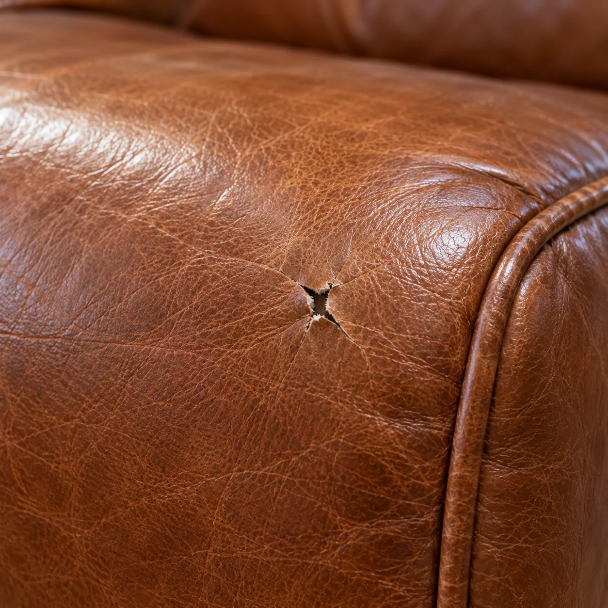 A puncture in a leather sofa from a move