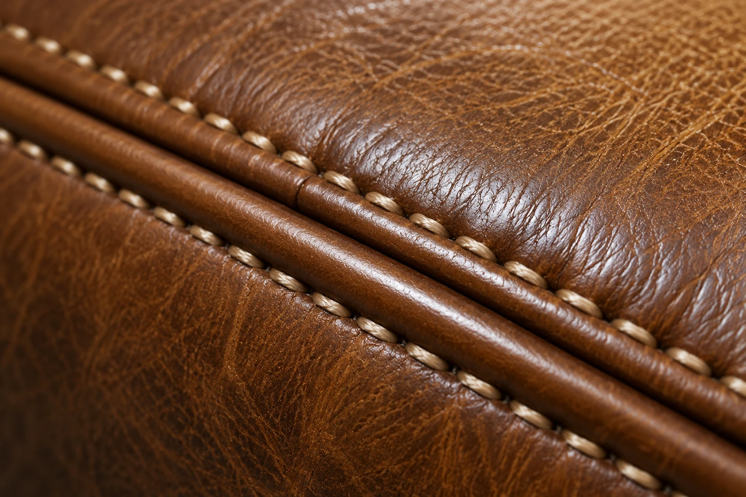 Leather seam stitched back along its piping