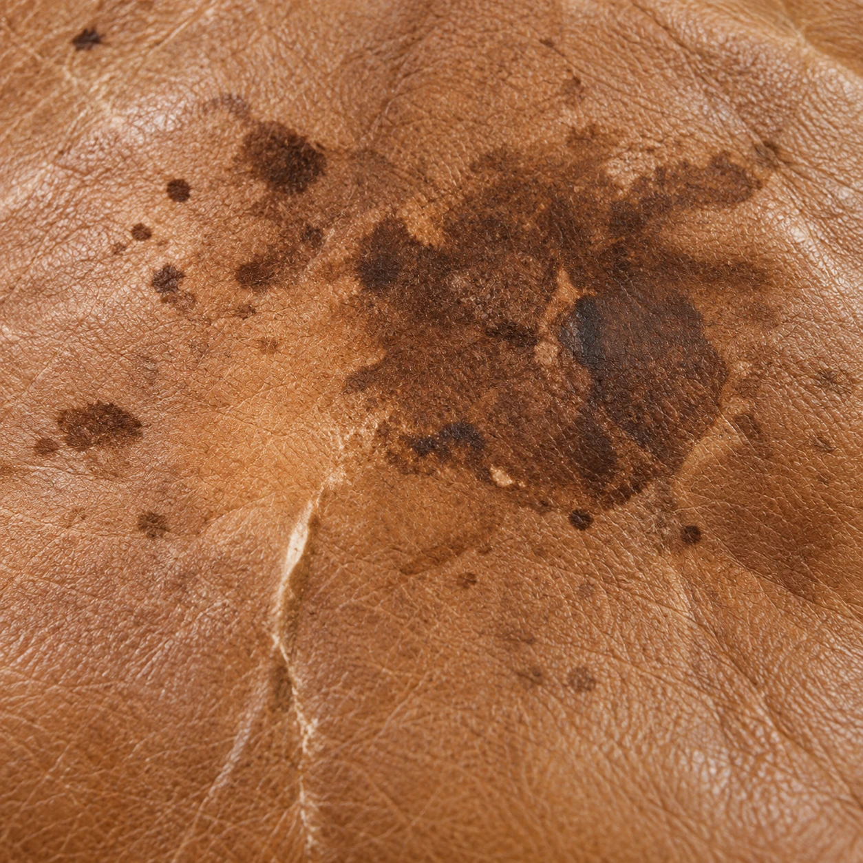 Dark marks on a tan leather seat