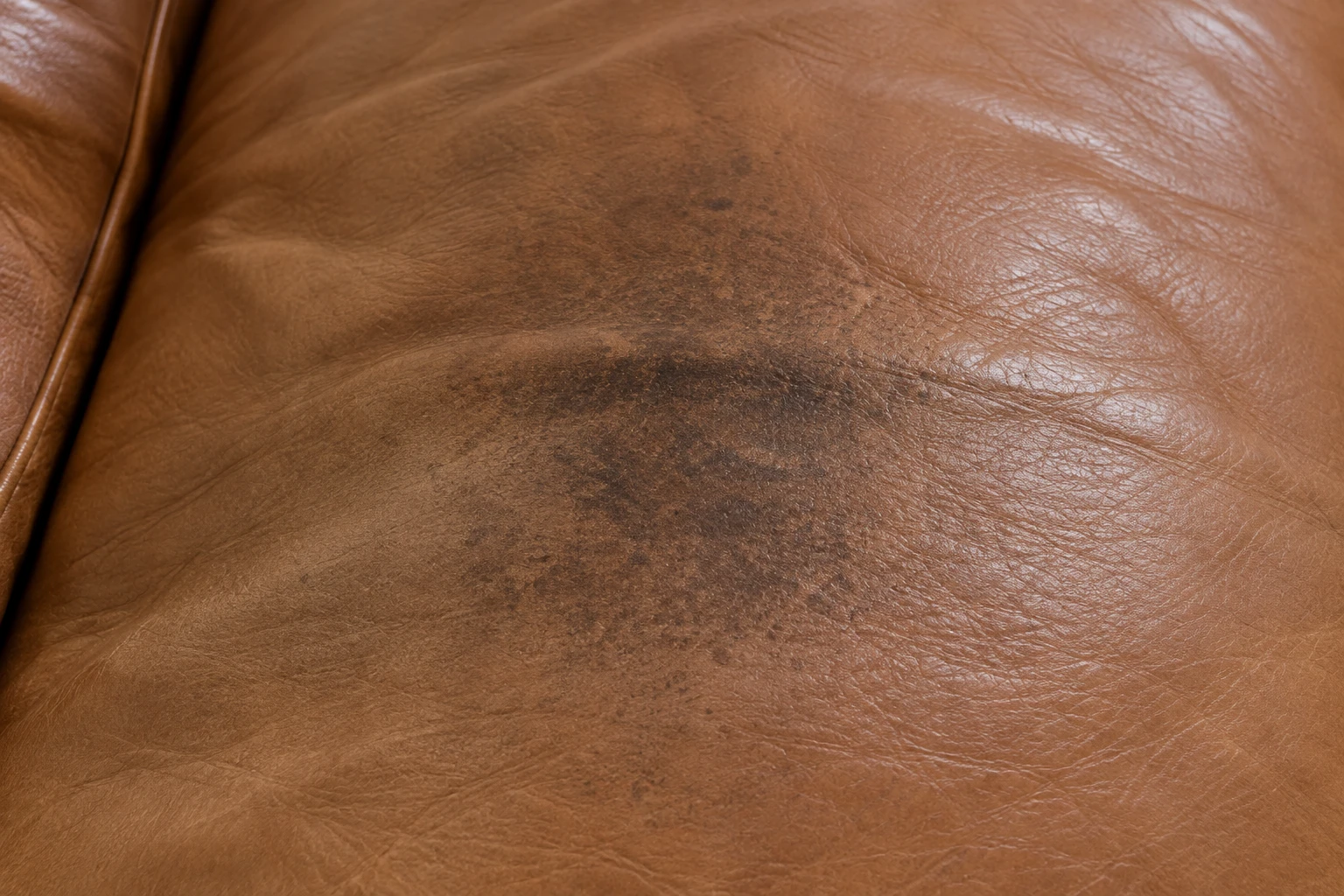Body oil darkening on brown leather