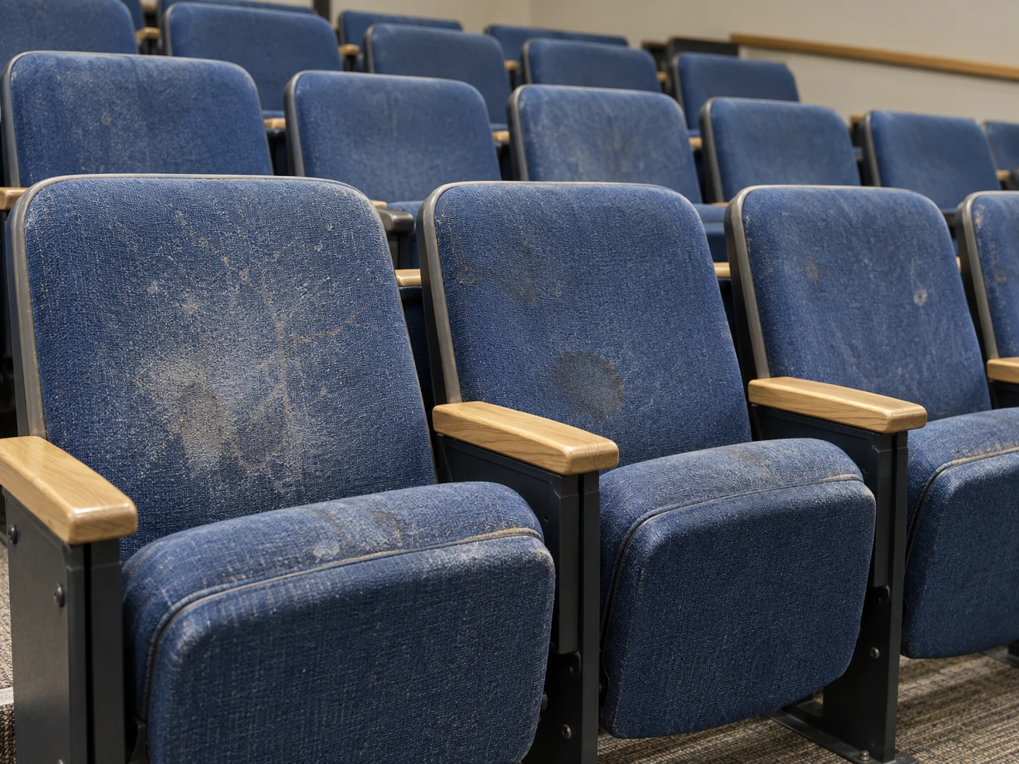 Before: stained and scuffed blue lecture hall seat covers