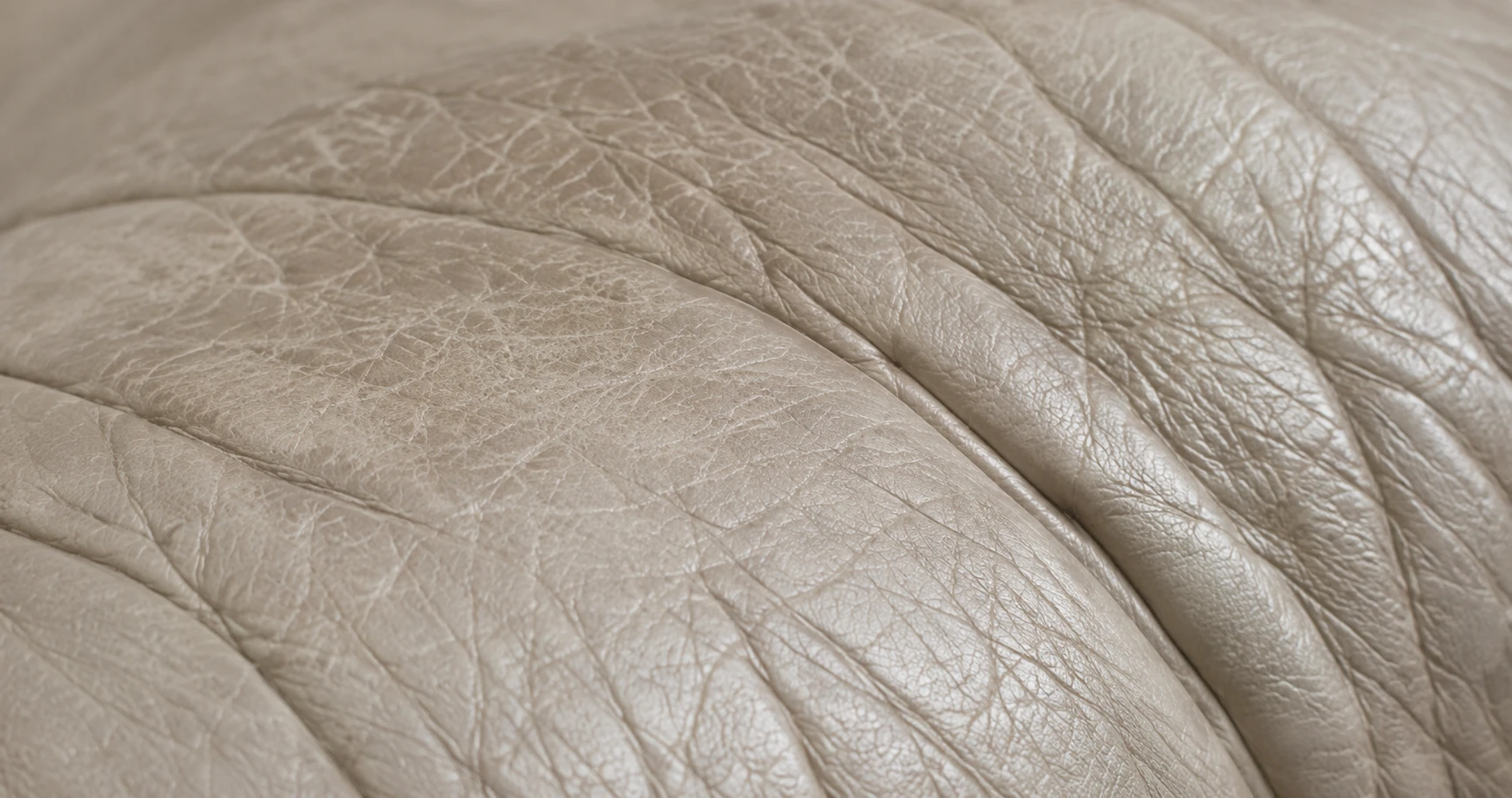 Soft grey film and creasing on pale leather