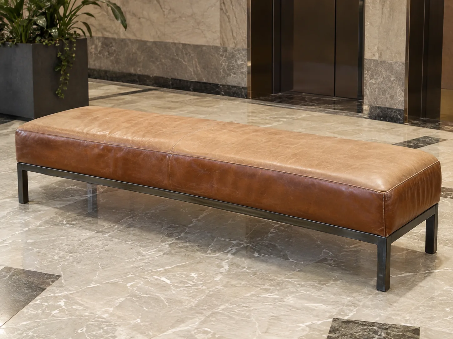A lobby bench before leather reupholstery