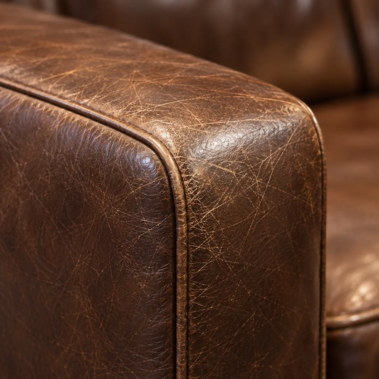 Scuffed leather on the arm of a lobby chair