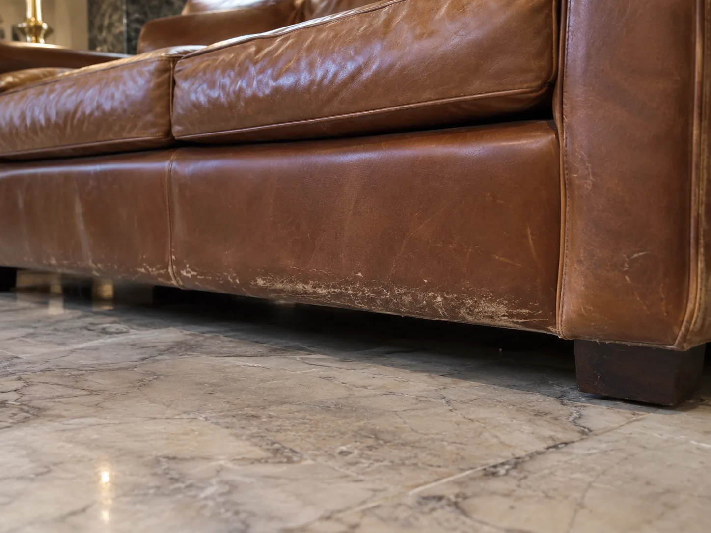 Scuffs along the base of a leather lobby sofa