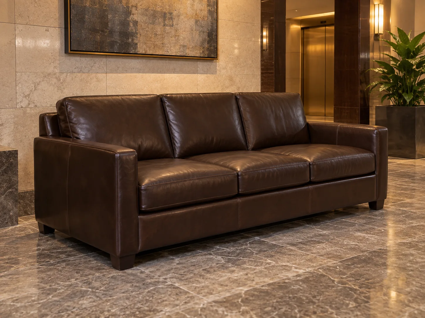 A dark brown leather sofa in a building lobby