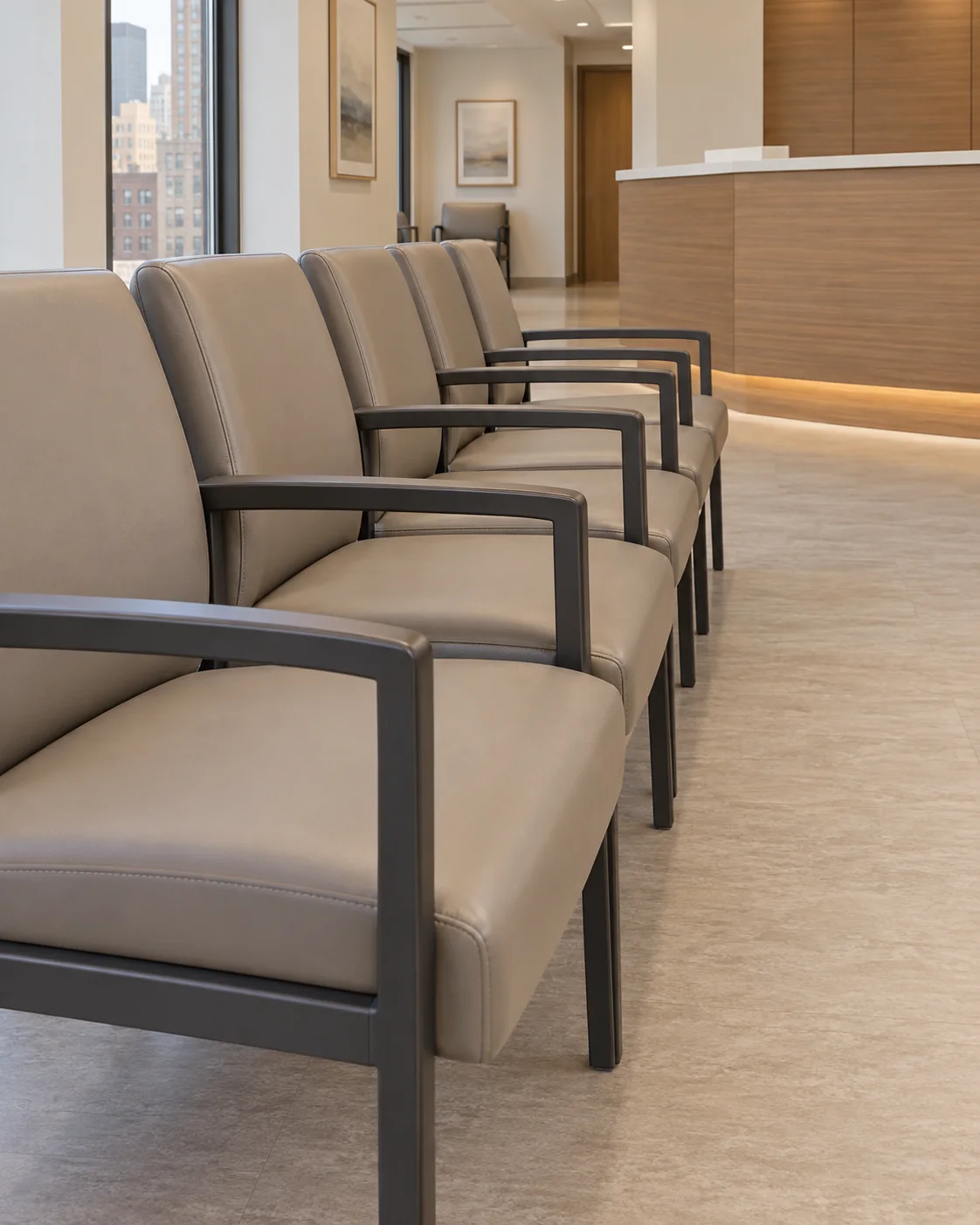 A row of taupe vinyl waiting room chairs in an empty medical office