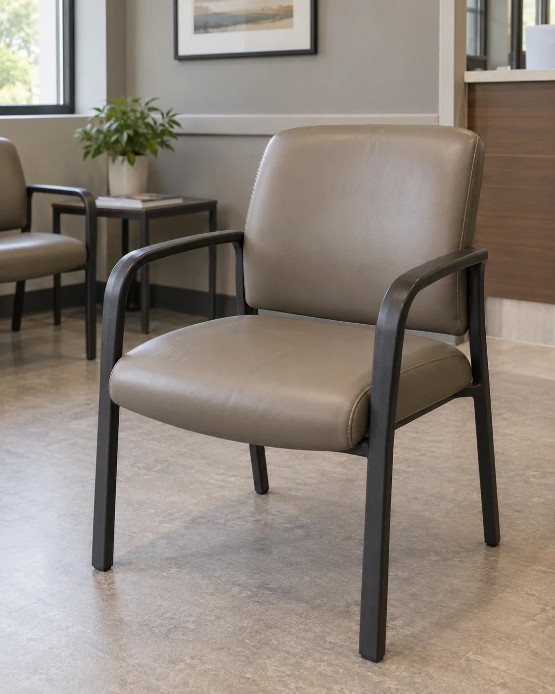 A metal-frame waiting room chair in taupe vinyl