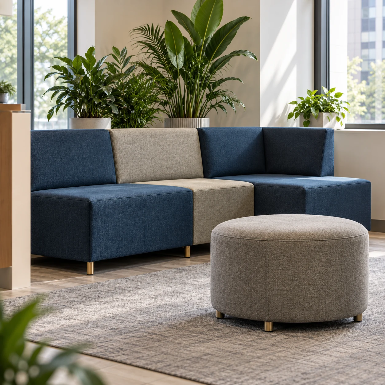 Modular blue lounge seating with a round ottoman