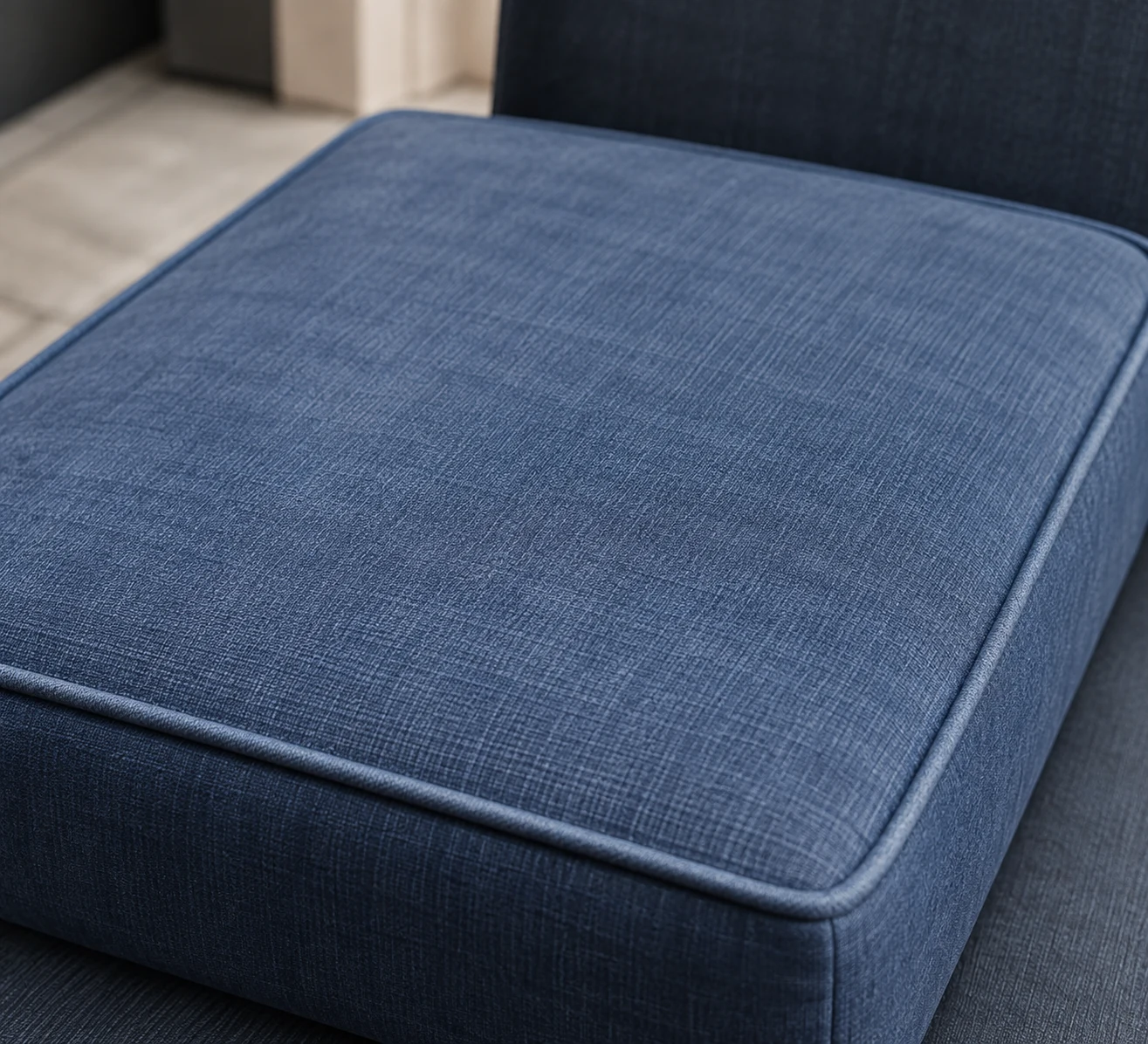 Navy outdoor seat cushion with a crisp welted edge