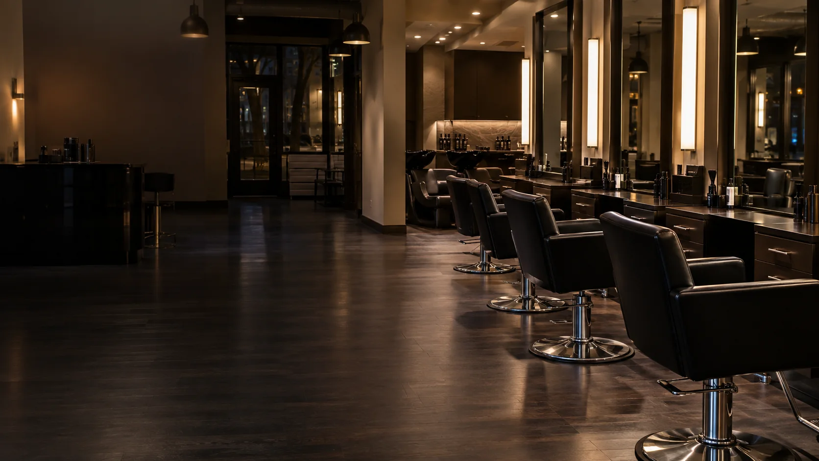 A NYC salon in the evening, styling stations lit and the floor empty
