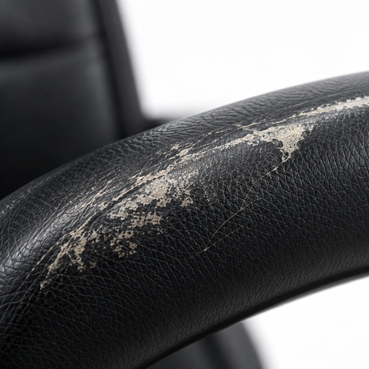 Peeling finish on an office chair armrest
